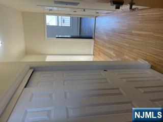 1518 River Road, Unit 3 Edgewater, NJ 07020 - Photo 4 of 19 a view of a hallway with wooden floor