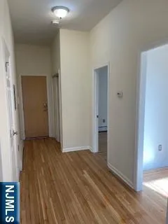 a view of a room with wooden floor