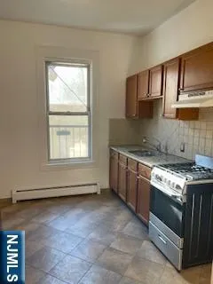 a kitchen with a stove and a sink