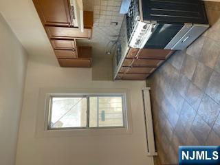 1518 River Road, Unit 3 Edgewater, NJ 07020 - Photo 9 of 19 a kitchen with a stove and a sink