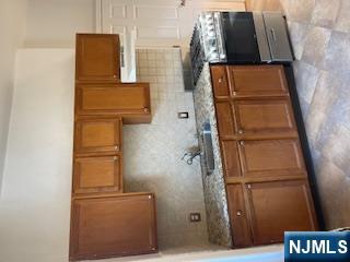 1518 River Road, Unit 3 Edgewater, NJ 07020 - Photo 10 of 19 a kitchen with stainless steel appliances granite countertop a sink and a stove