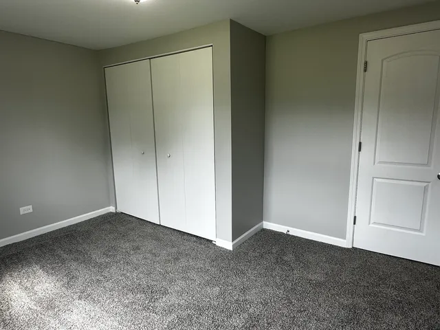 an empty room with closet area