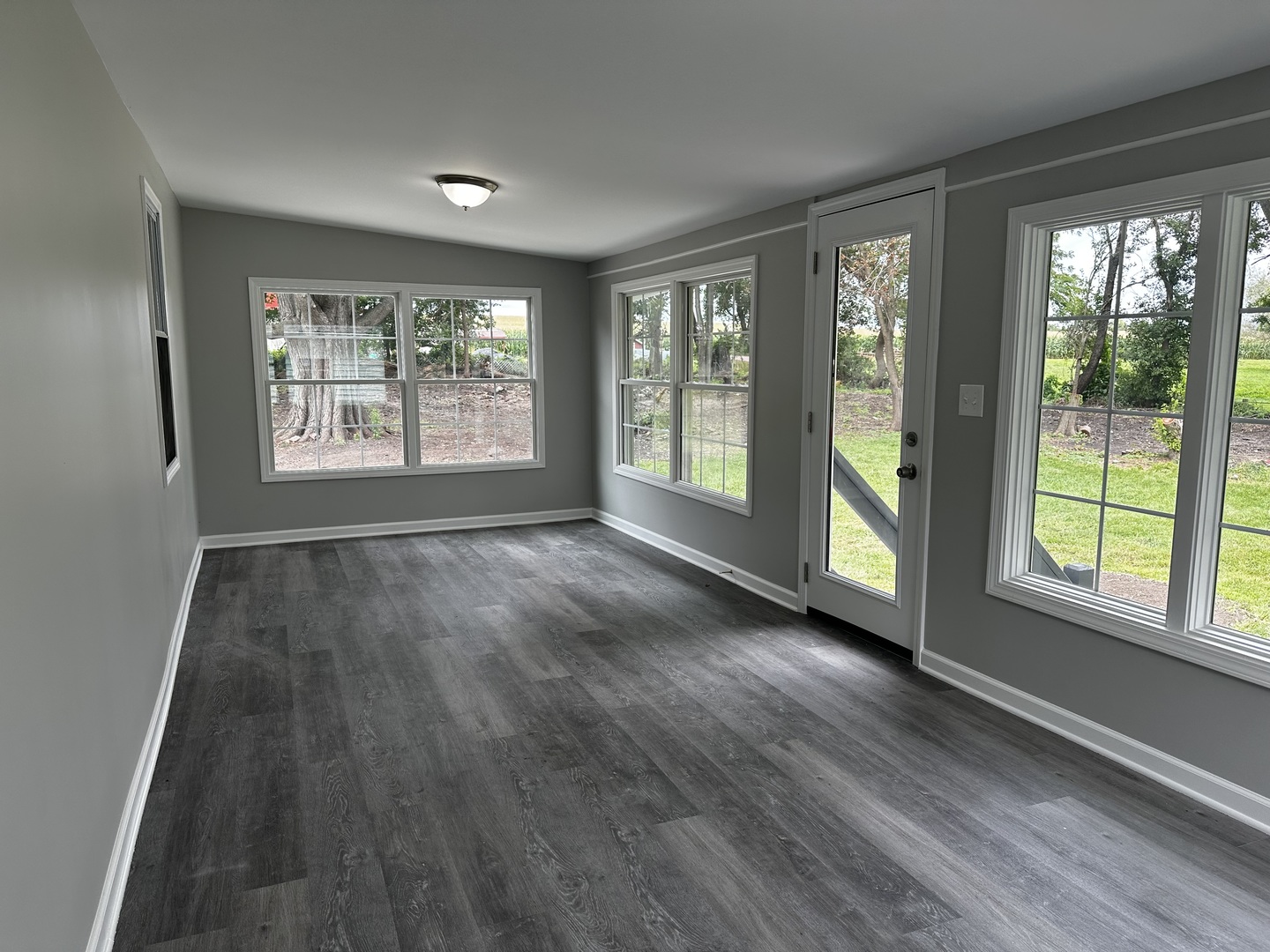 764 Brooklyn Road West Brooklyn, IL 61378 - Photo 25 of 33 a view of an empty room with wooden floor and a window