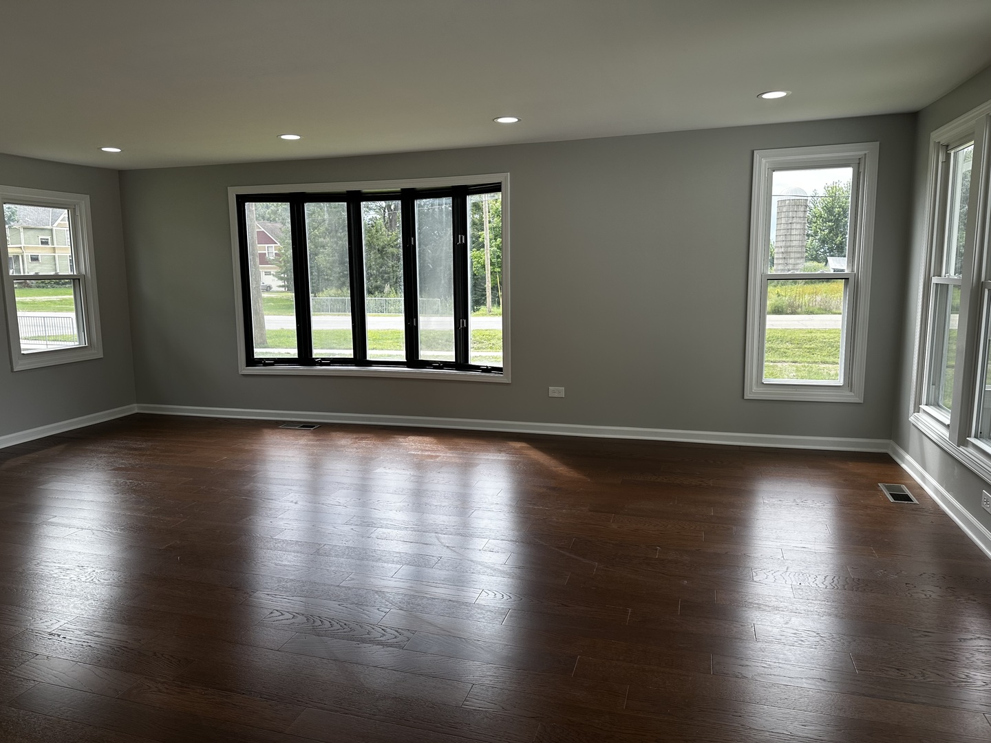 764 Brooklyn Road West Brooklyn, IL 61378 - Photo 5 of 33 an empty room with wooden floor and windows