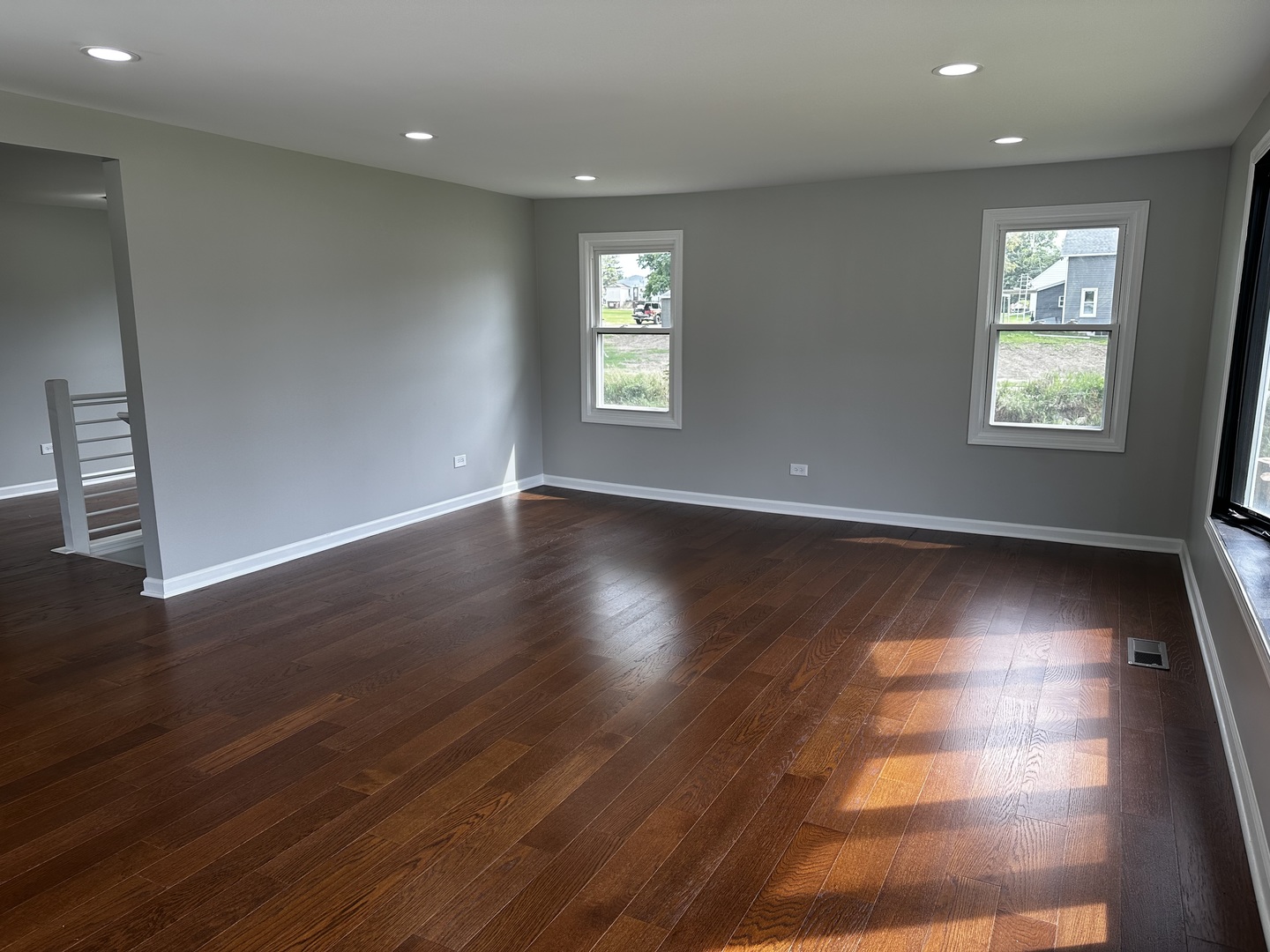764 Brooklyn Road West Brooklyn, IL 61378 - Photo 6 of 33 an empty room with wooden floor and windows