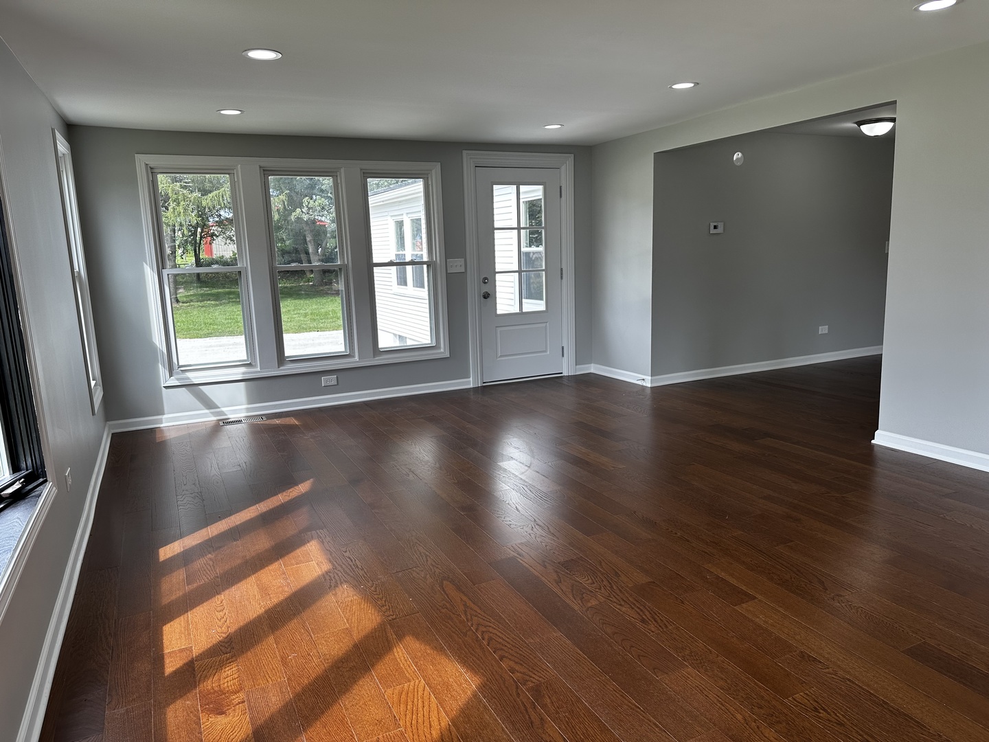 764 Brooklyn Road West Brooklyn, IL 61378 - Photo 7 of 33 an empty room with wooden floor and windows