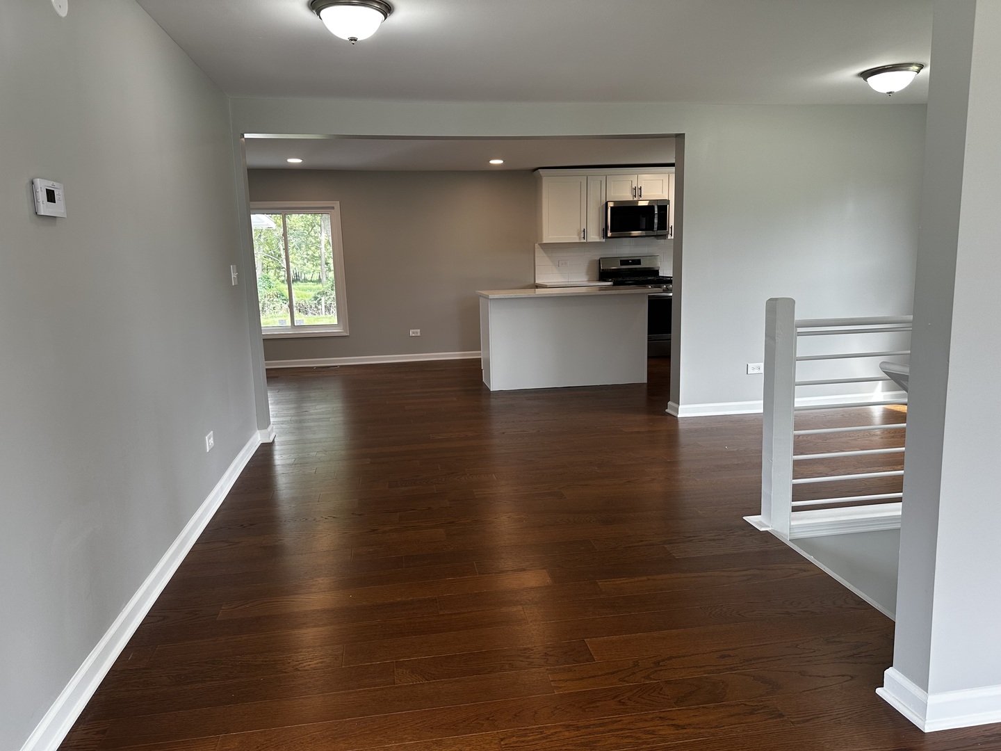764 Brooklyn Road West Brooklyn, IL 61378 - Photo 8 of 33 a view of a kitchen with wooden floor a sink and windows