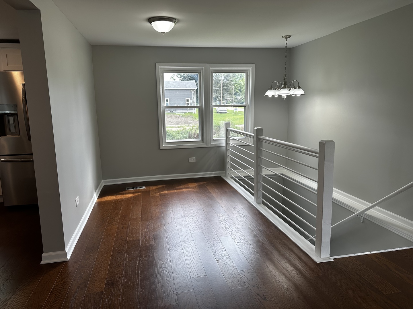 764 Brooklyn Road West Brooklyn, IL 61378 - Photo 9 of 33 an empty room with wooden floor and windows
