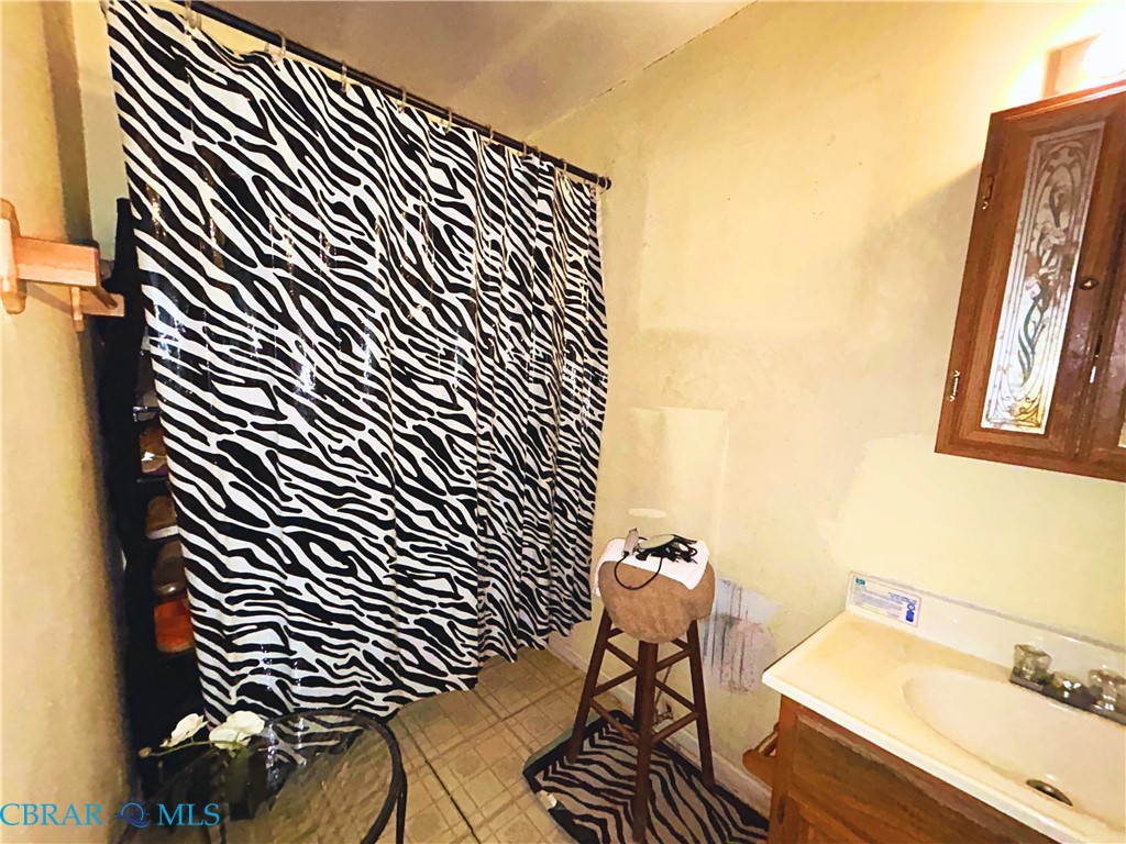 449 Gaskins Road Weems, VA 22576 - Photo 7 of 10 a bathroom with a sink and a mirror