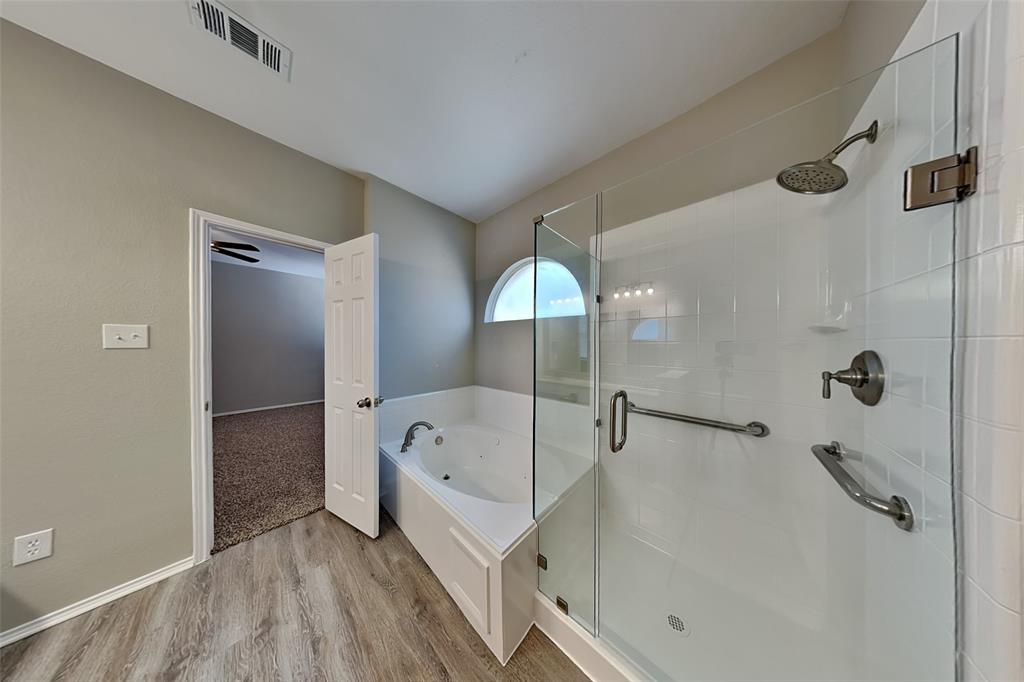 1056 Pullman Drive Saginaw, TX 76131 - Photo 12 of 27 a bathroom with a bathtub and a shower