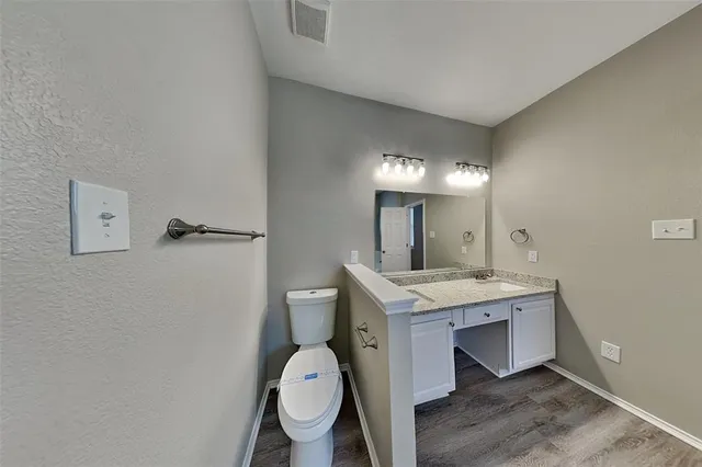a view of bathroom with a toilet sink and mirror