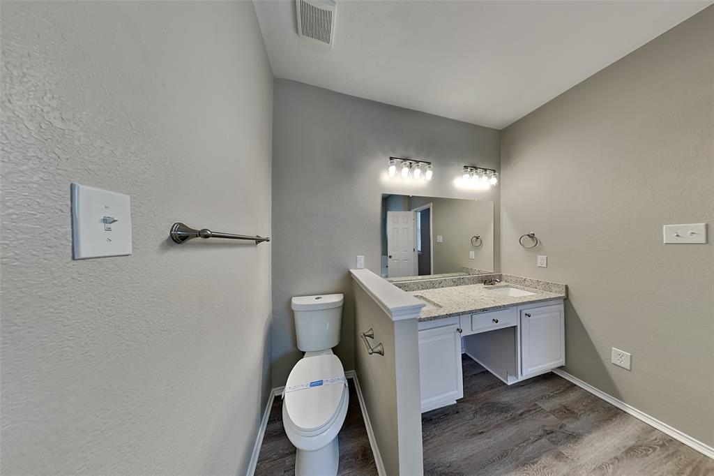 1056 Pullman Drive Saginaw, TX 76131 - Photo 13 of 27 a view of bathroom with a toilet sink and mirror