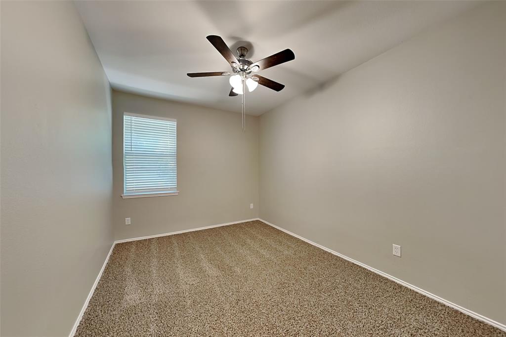 1056 Pullman Drive Saginaw, TX 76131 - Photo 15 of 27 an empty room with window and ceiling fan