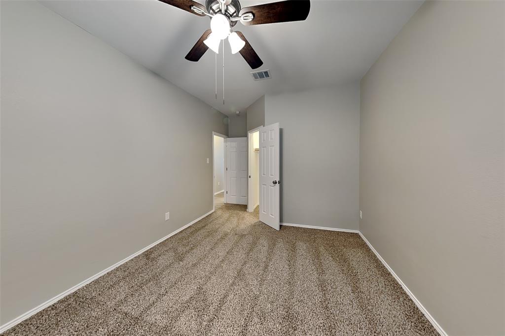 1056 Pullman Drive Saginaw, TX 76131 - Photo 18 of 27 an empty room with a ceiling fan and carpet
