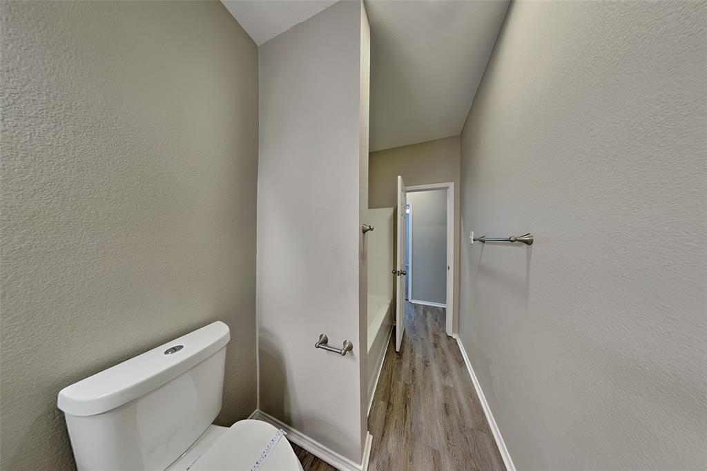 1056 Pullman Drive Saginaw, TX 76131 - Photo 21 of 27 a bathroom with a toilet and a shower