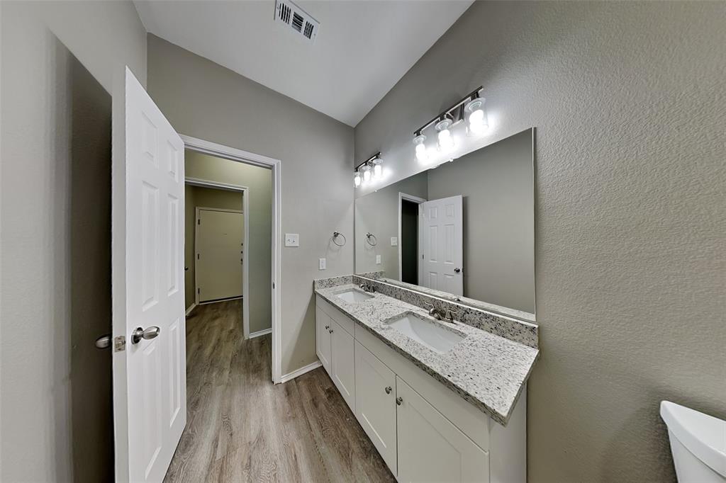 1056 Pullman Drive Saginaw, TX 76131 - Photo 22 of 27 a bathroom with a granite countertop sink and a mirror