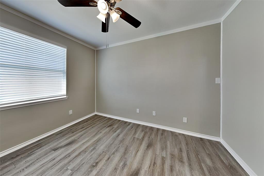 1056 Pullman Drive Saginaw, TX 76131 - Photo 23 of 27 wooden floor in an empty room with a window