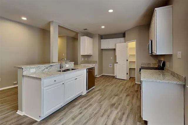 a kitchen with a sink stove and cabinets