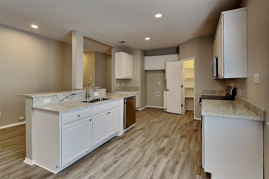 1056 Pullman Drive Saginaw, TX 76131 - Photo 9 of 27 a kitchen with a sink stove and cabinets