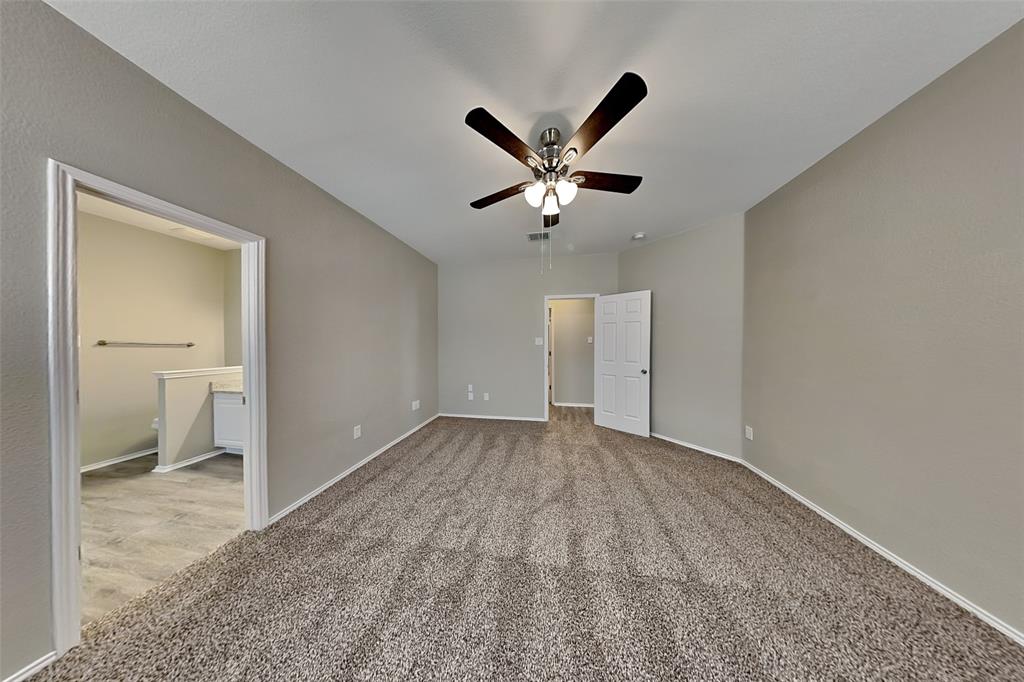1056 Pullman Drive Saginaw, TX 76131 - Photo 10 of 27 a view of a room with a ceiling fan and bathroom