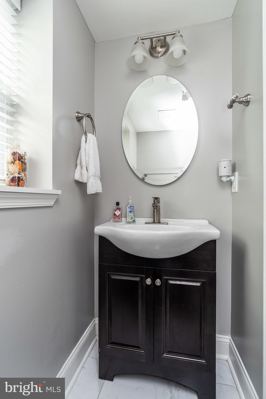 365 Bonsal Street Baltimore, MD 21224 - Photo 14 of 36 a bathroom with a sink and a mirror