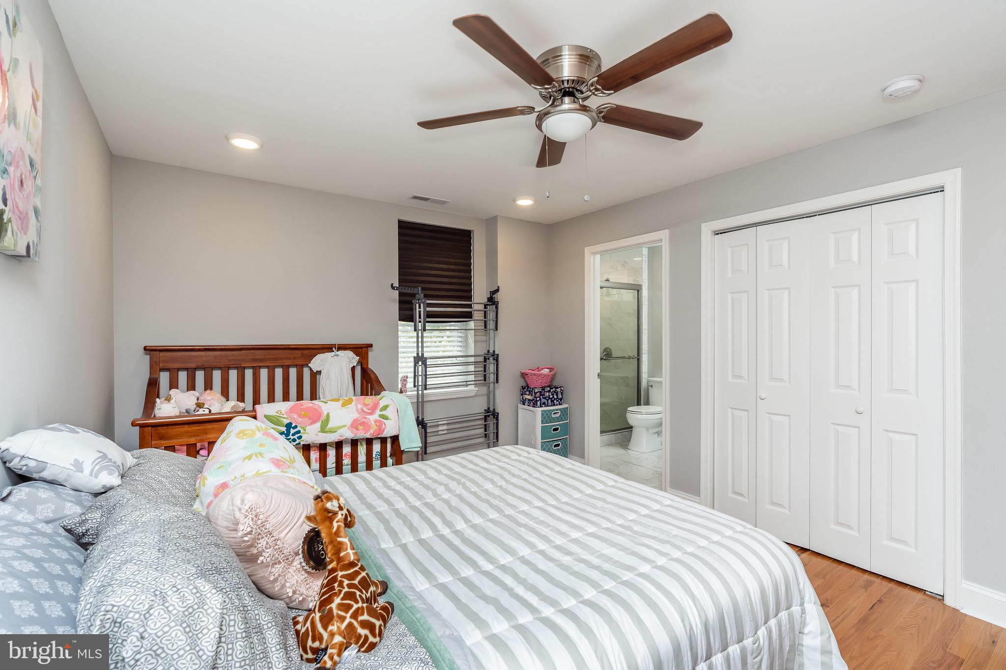 365 Bonsal Street Baltimore, MD 21224 - Photo 16 of 36 a bedroom with a bed and a chandelier