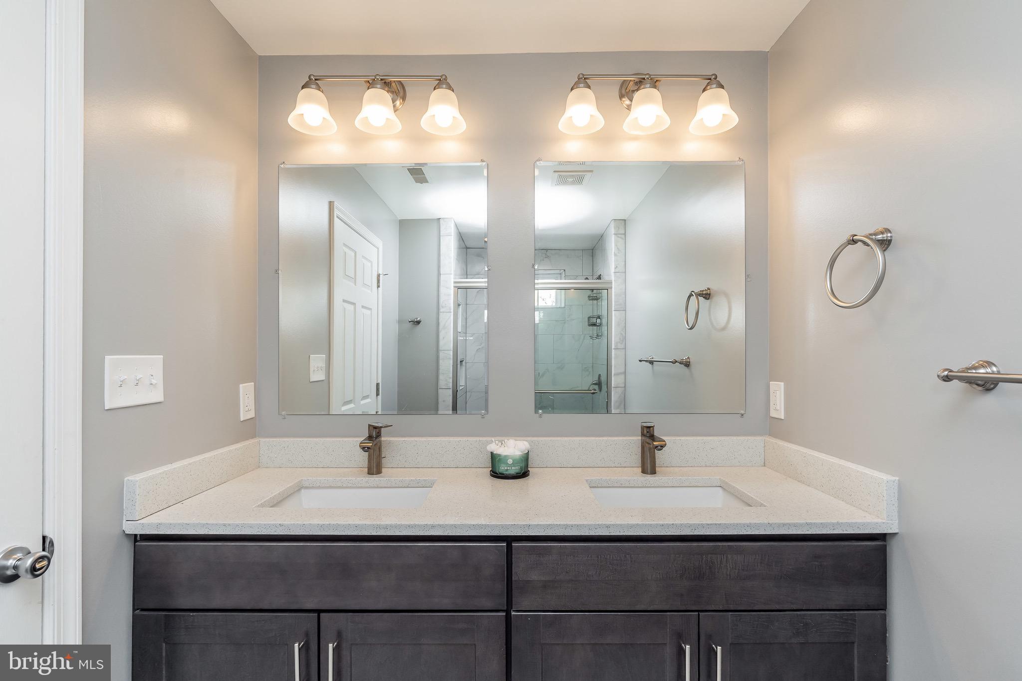 365 Bonsal Street Baltimore, MD 21224 - Photo 22 of 36 a bathroom with double vanity sinks and a mirror