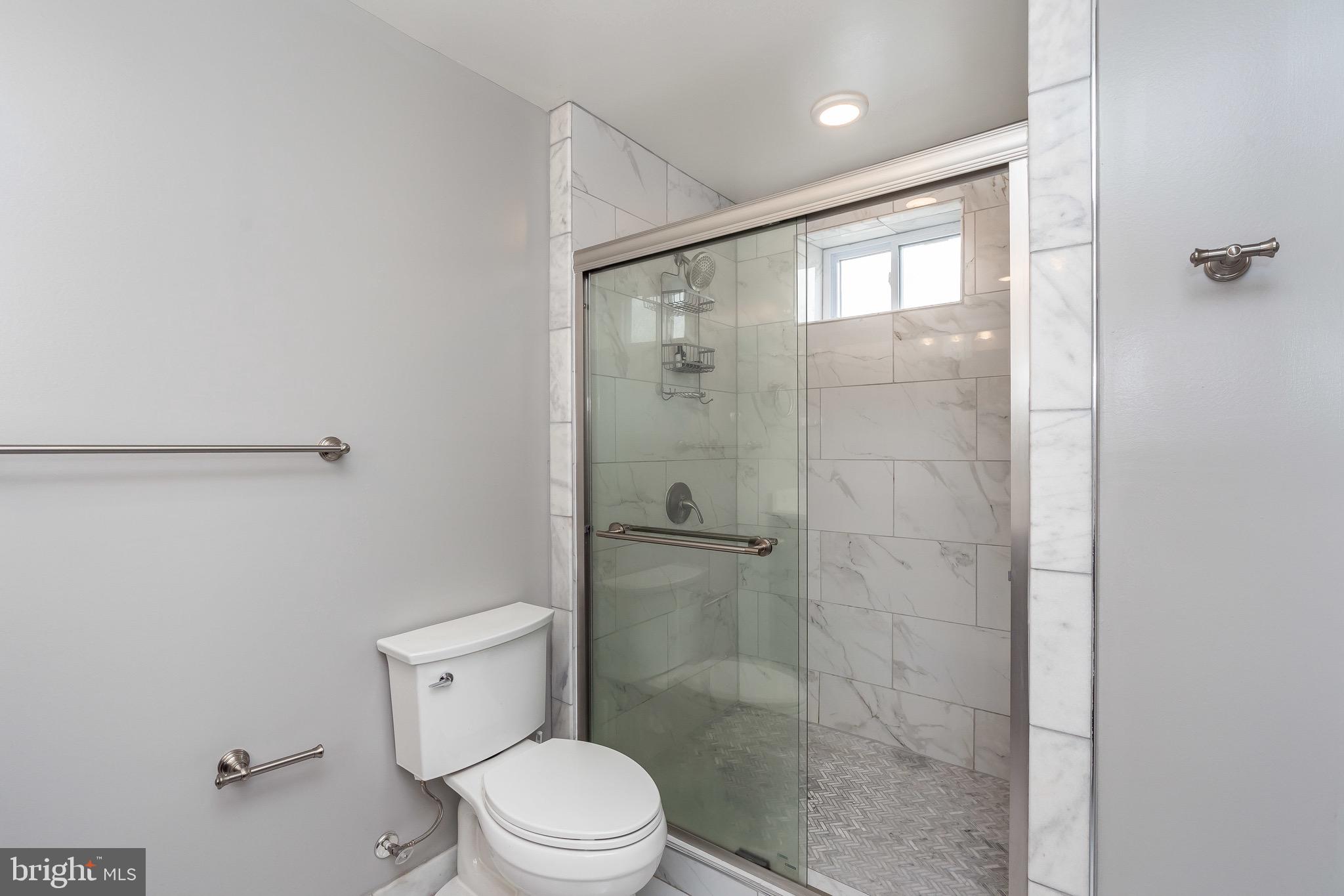 365 Bonsal Street Baltimore, MD 21224 - Photo 23 of 36 a bathroom with a shower a toilet and a sink