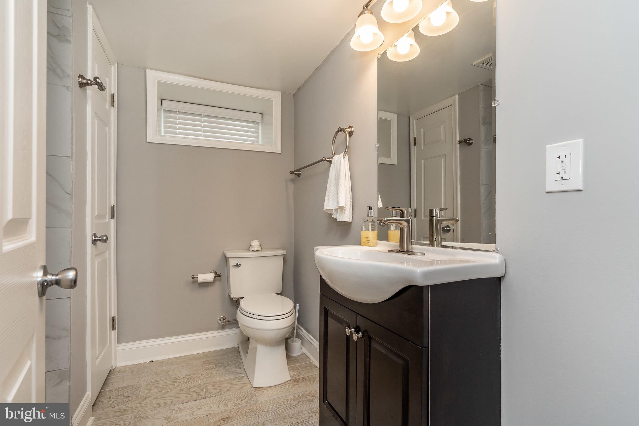 365 Bonsal Street Baltimore, MD 21224 - Photo 26 of 36 a bathroom with a sink a toilet and a mirror