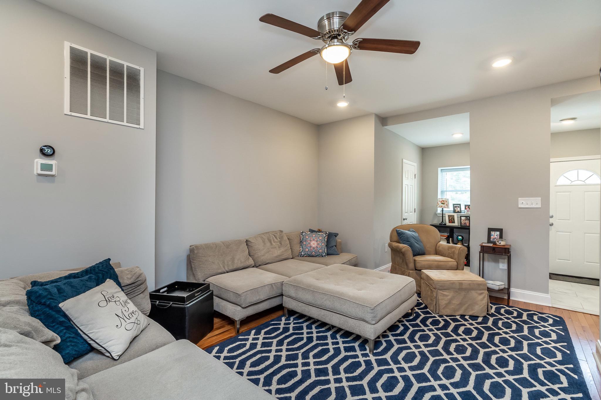 365 Bonsal Street Baltimore, MD 21224 - Photo 3 of 36 a bedroom with furniture and a chandelier