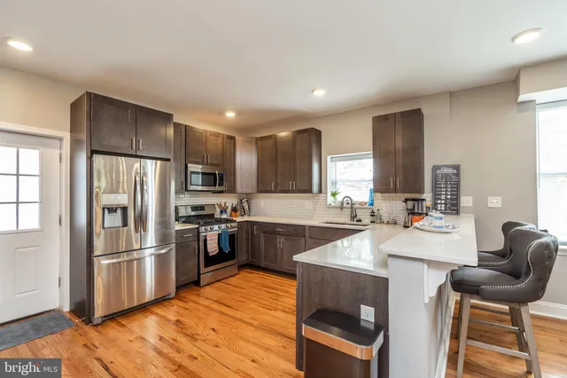 a kitchen with granite countertop a sink appliances and cabinets