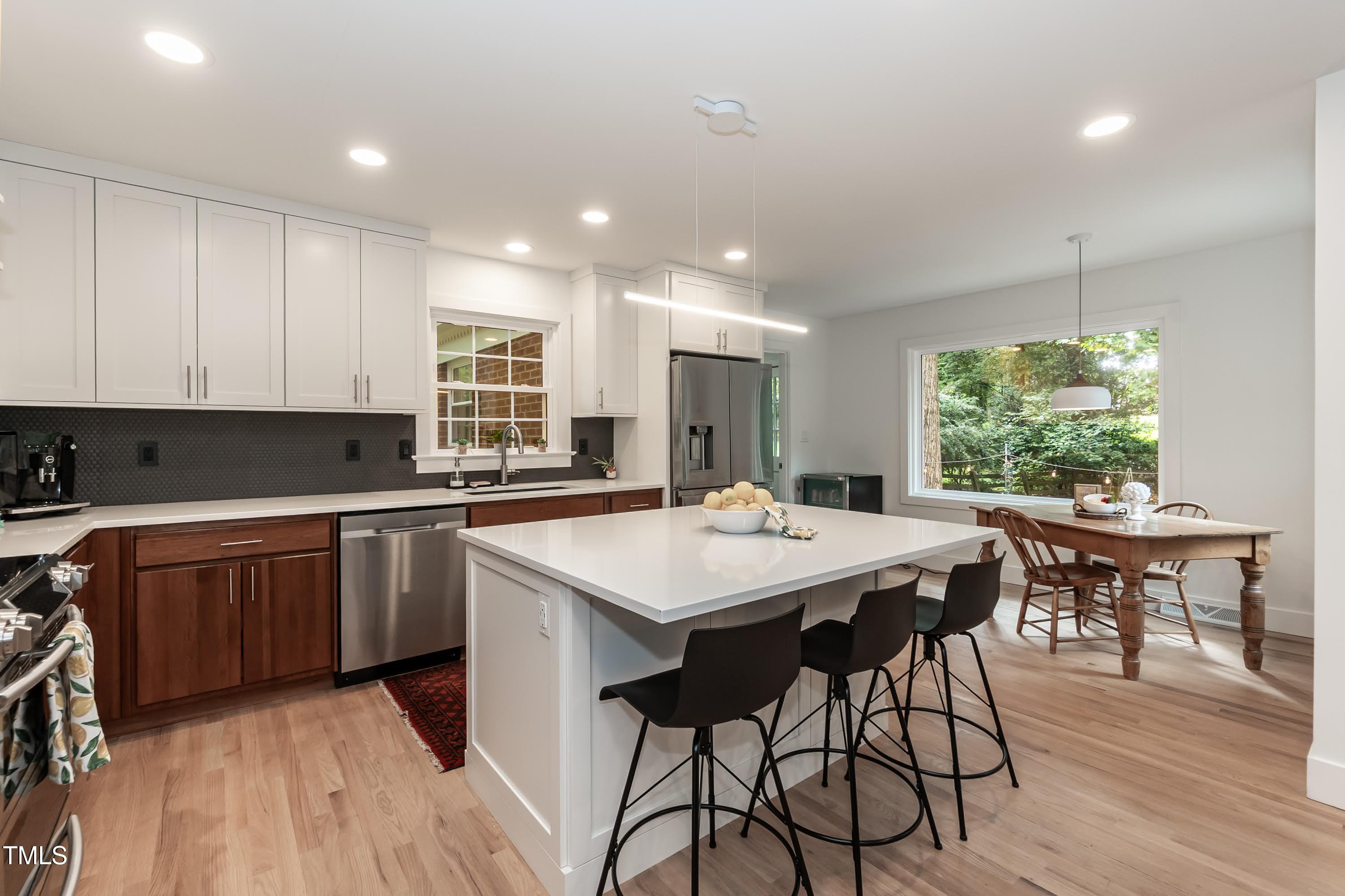 9024 Oneal Road Raleigh, NC 27613 - Photo 12 of 40 This gourmet style kitchen with cherry wood lower cabinets and maple white uppers with soft close.