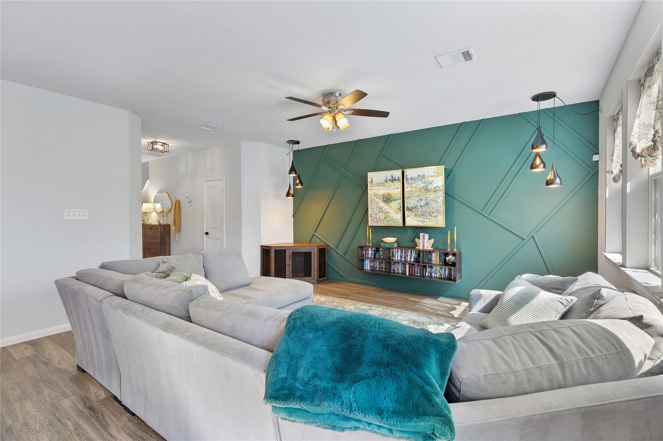 18623 Jerrara Stream Lane Katy, TX 77449 - Photo 2 of 46 The large, open concept living room has a bold feature wall, added lighting, and a floating TV console. Modern design with functional charm!