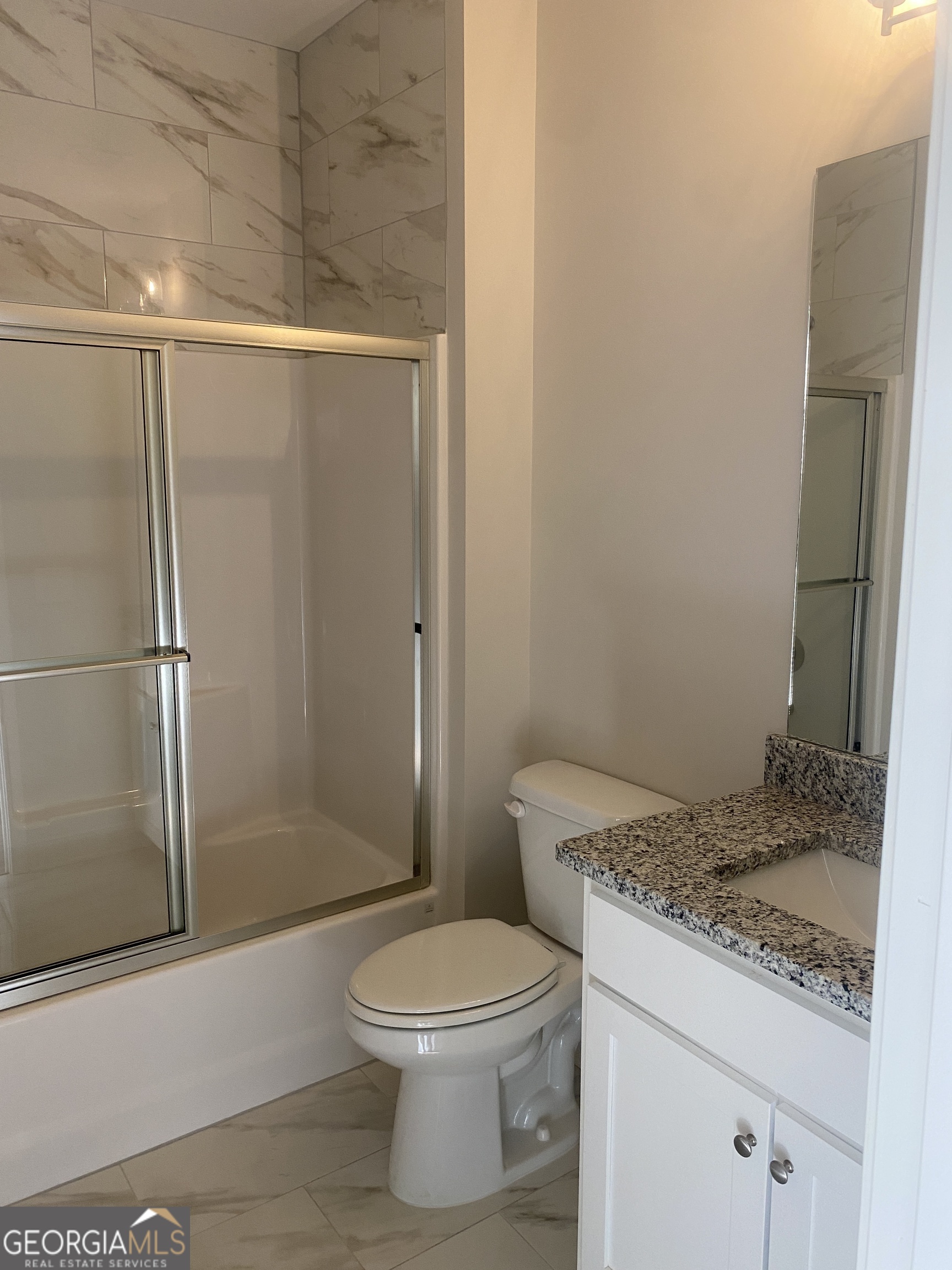 296 Delightful Way, Unit 22 Winder, GA 30680 - Photo 11 of 13 a bathroom with a granite countertop sink toilet and shower