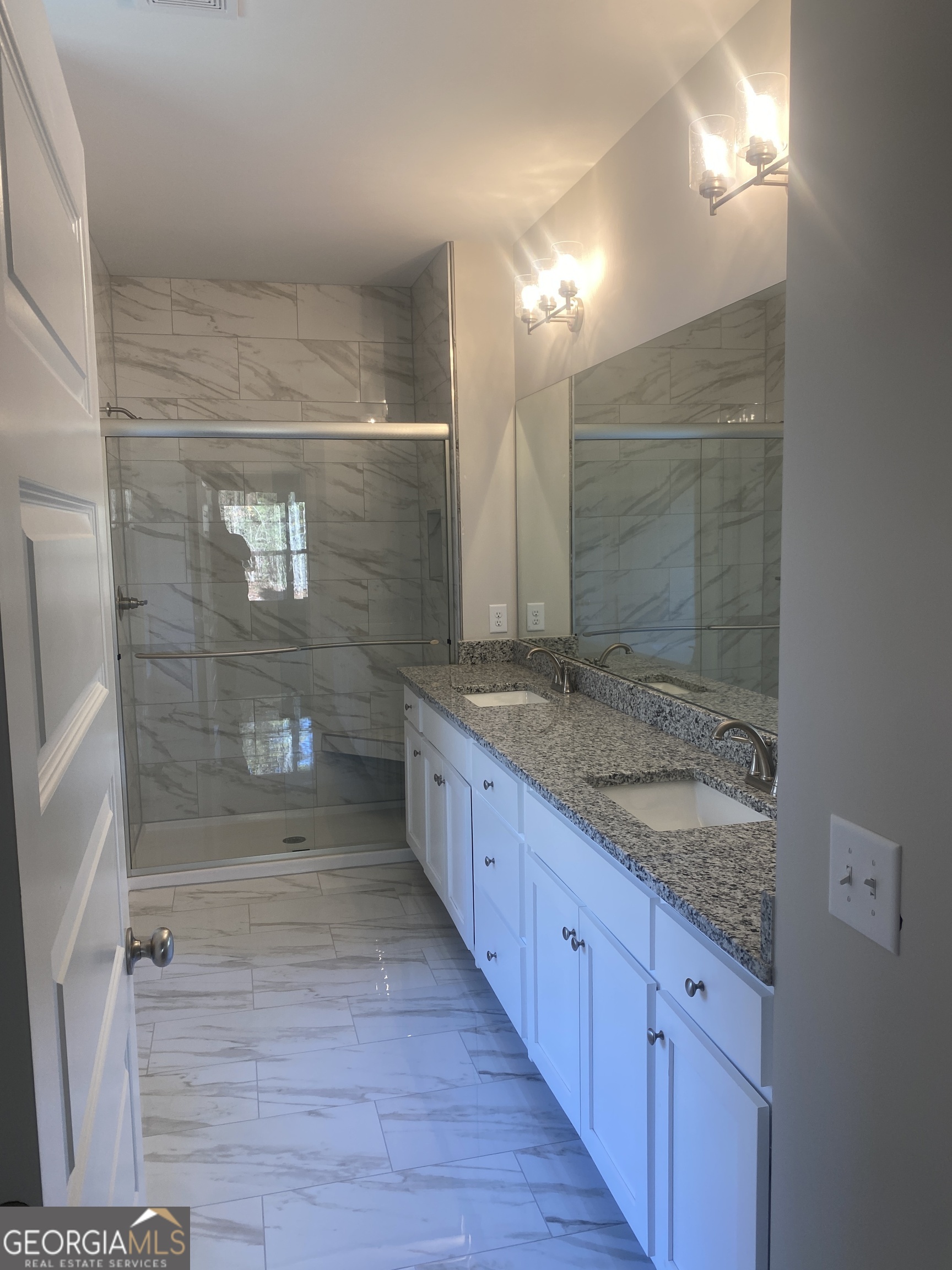296 Delightful Way, Unit 22 Winder, GA 30680 - Photo 8 of 13 a bathroom with a granite countertop sink mirror and shower