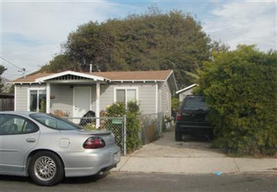 a front view of a house with parking space