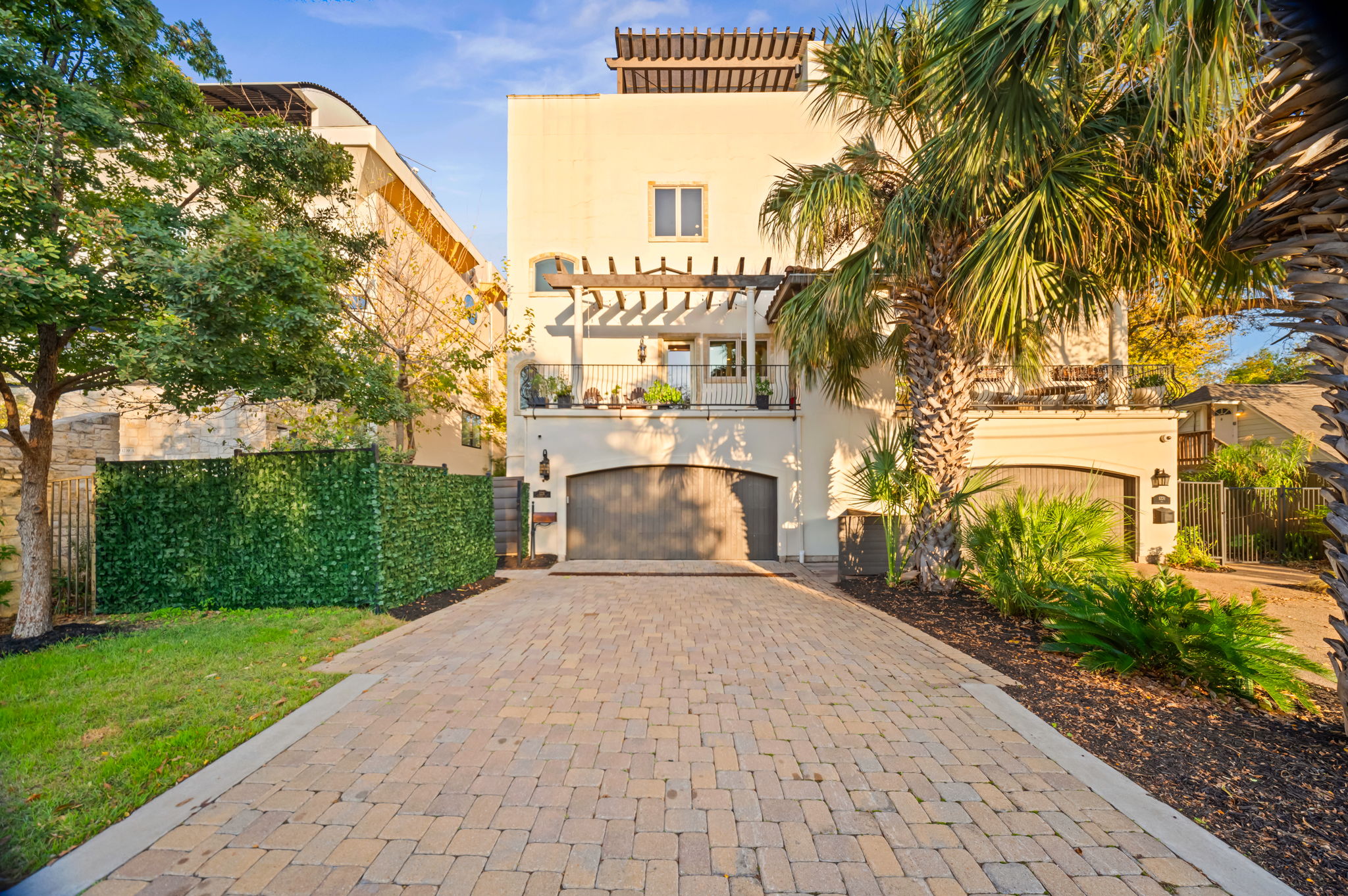 Distinct Santa Barbara style architecture with stone drive and mature low maintenance landscaping