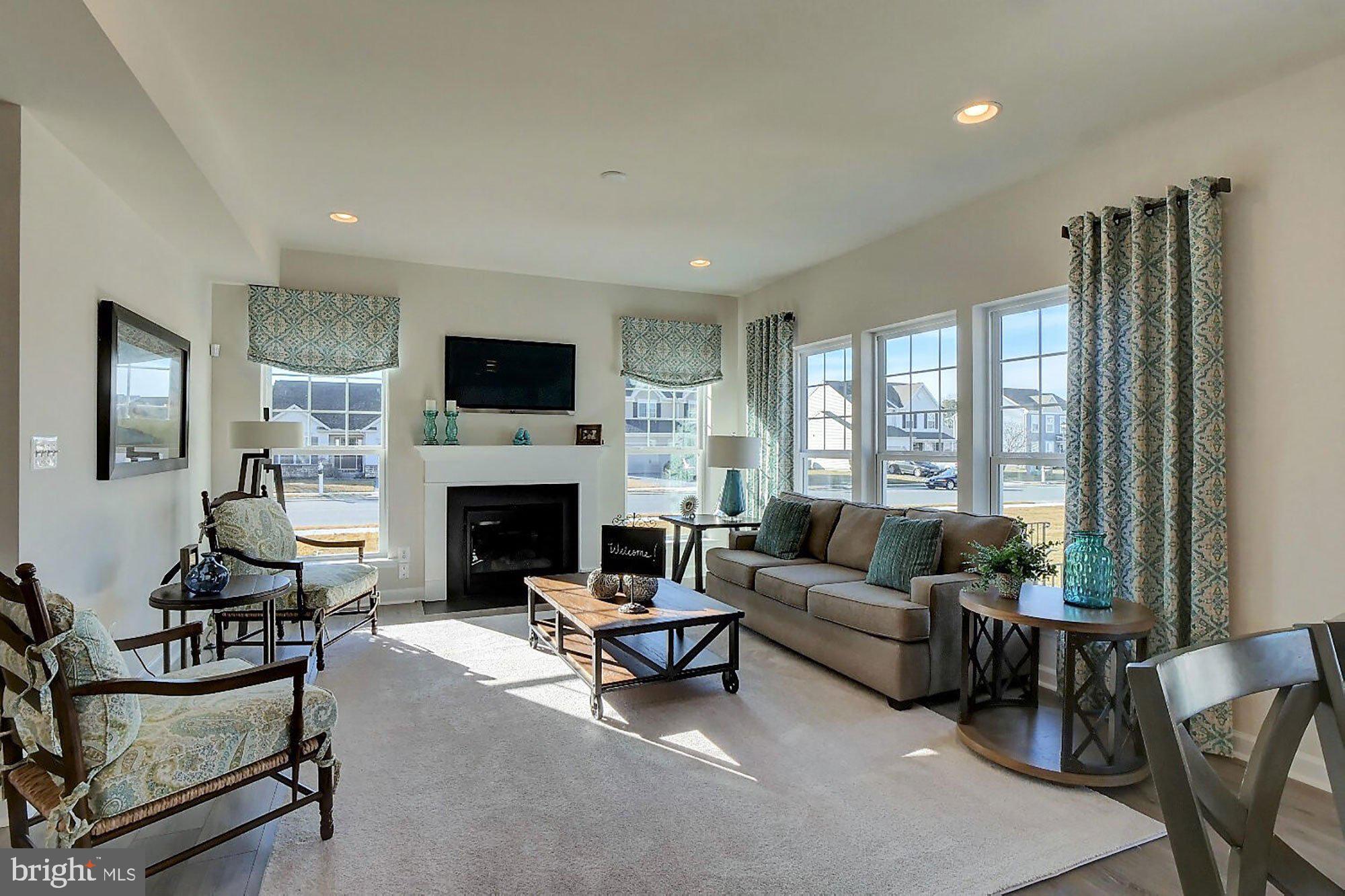 1546 Shipsview Road Annapolis, MD 21409 - Photo 3 of 13 a living room with furniture a fireplace and a flat screen tv
