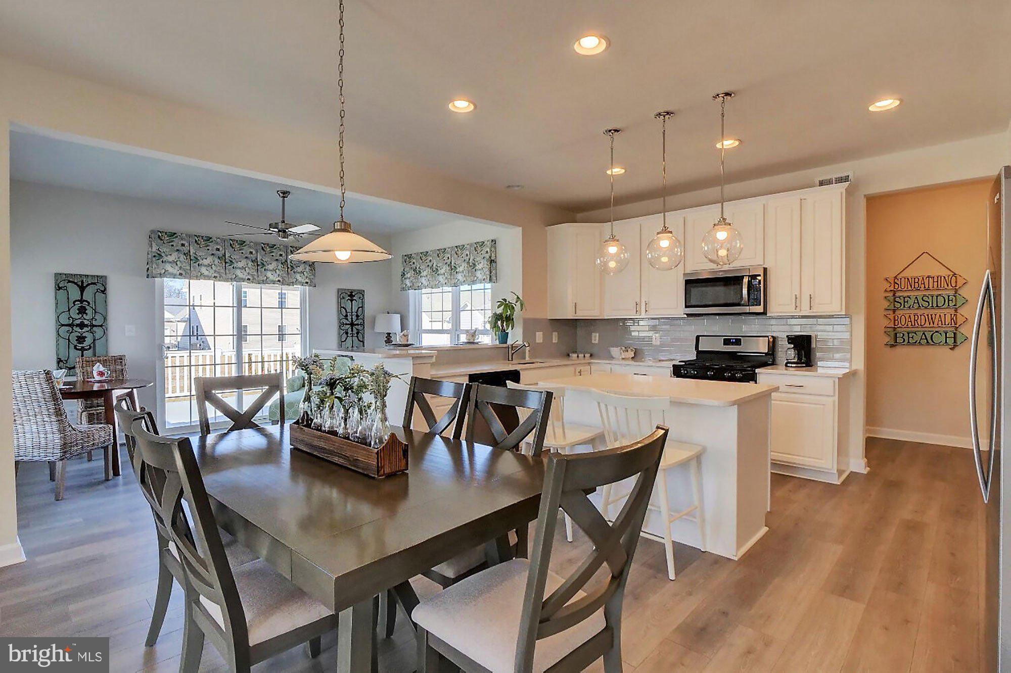 1546 Shipsview Road Annapolis, MD 21409 - Photo 8 of 13 a view of a dining room and livingroom with furniture wooden floor kitchen chandelier