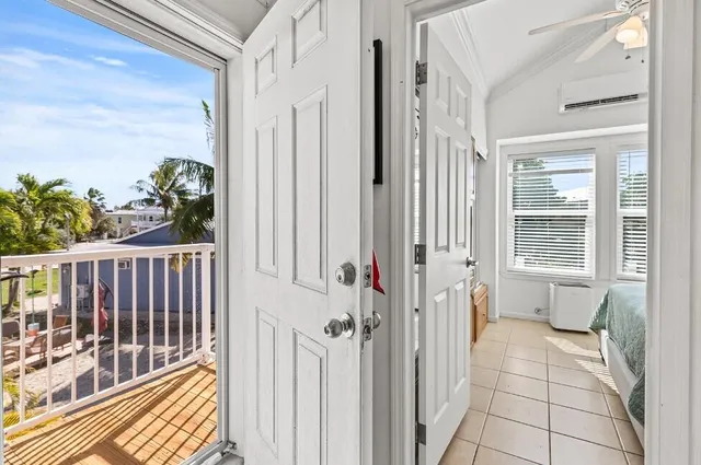 a view of a kitchen with fridge and wooden floor