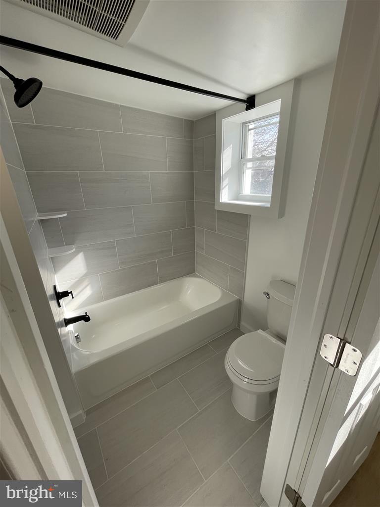1509 Lemmon Street Baltimore, MD 21223 - Photo 11 of 14 a bath room with a toilet and a bath tub