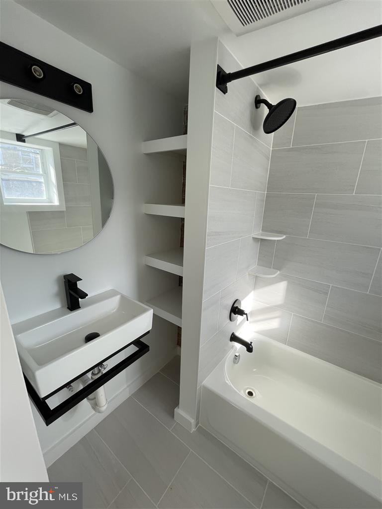 1509 Lemmon Street Baltimore, MD 21223 - Photo 10 of 14 a bathroom with a tub sink vanity and shower