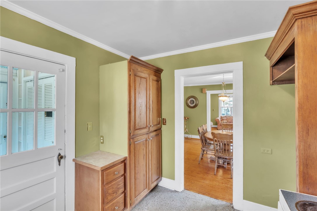121 Ellison Street Belton, SC 29627 - Photo 11 of 30 This bright kitchen with crown molding and tile flooring offers a seamless transition to the inviting dining area.