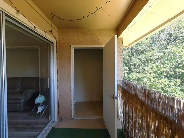 a view of a door and wooden floor
