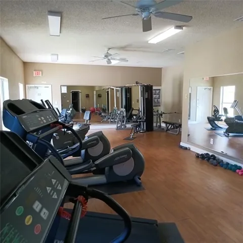 an empty room with gym equipment and a large window