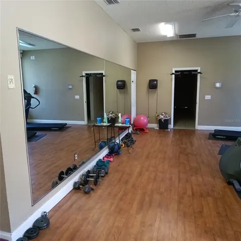 a view of a patio with table and chairs with wooden fence and plants