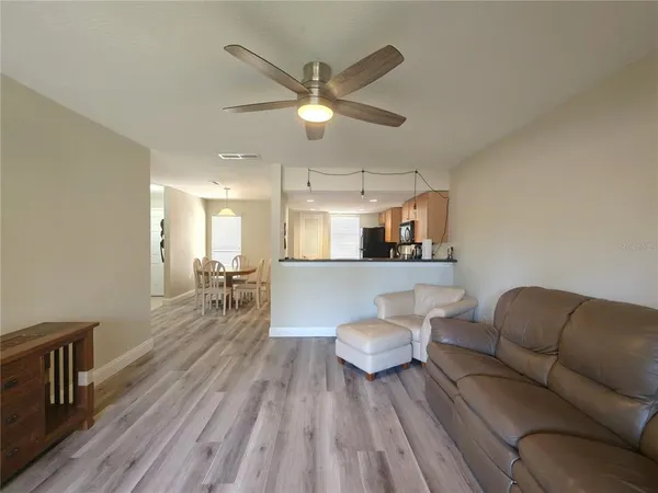 a living room with furniture and a wooden floor