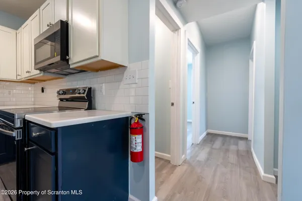 a kitchen with kitchen island a sink stainless steel appliances and cabinets