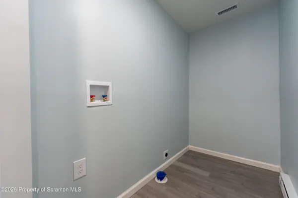 a open kitchen with stainless steel appliances a refrigerator and a microwave