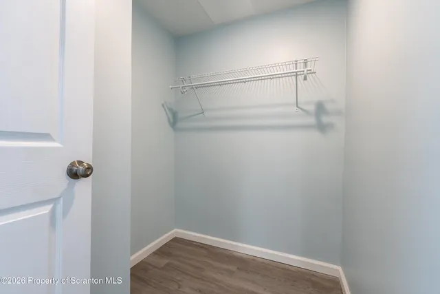 a view of an empty room and wooden floor